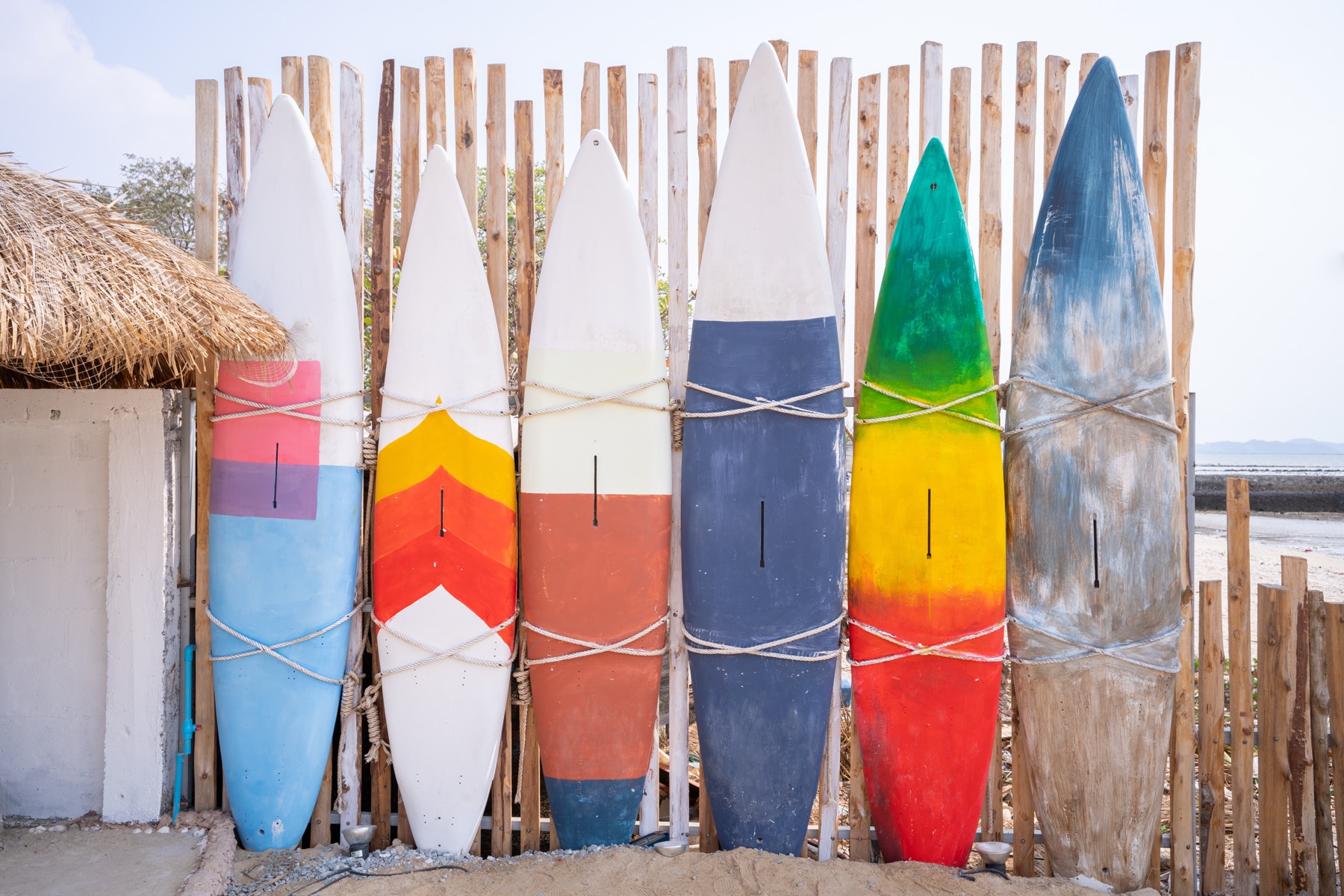Colorful surfboards lined up on the beach